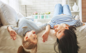 Mom And Daughter Lying Upside Down On Bed